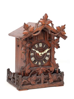 Lot 4 - A LATE 19TH CENTURY BLACK FOREST CARVED WOOD CUCKOO CLOCK