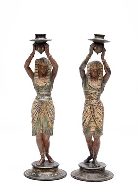 Lot A PAIR OF PAINTED SPELTER EGYPTIAN FIGURAL CANDLESTICKS