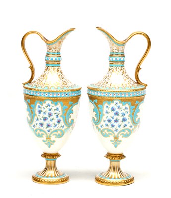 Lot DESIRE LEROY (1840-1908) A PAIR OF EARLY 20TH CENTURY ROYAL CROWN DERBY PORCELAIN EWERS