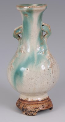 Lot 113 - A CHINESE CREAM AND CELEDON SLIPWARE VASE of...