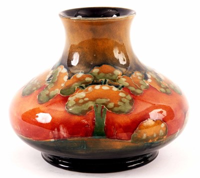 Lot 44 - A WILLIAM MOORCROFT SQUAT BULBOUS CABINET VASE...