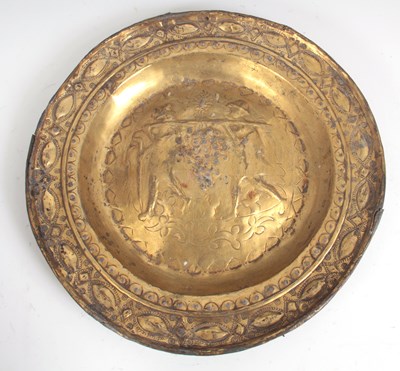 Lot 627 - A 17TH CENTURY BRASS ALMS DISH depicting two...