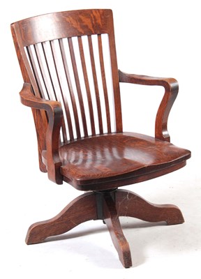 Lot 1060 - AN EARLY 2OTH CENTURY OAK REVOLVING DESK CHAIR...