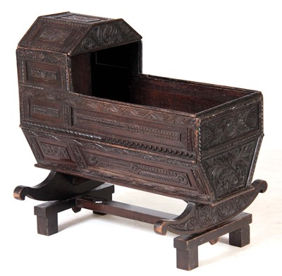 Lot 1092 - A 19TH CENTURY CARVED OAK CHILDS CRIB fitted...