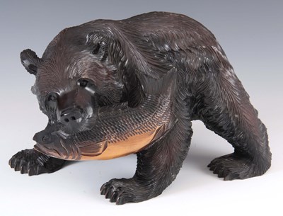 Lot 426 - A CARVED WOOD EBONISED SCULPTURE formed as a...