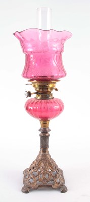Lot 496 - A 19TH CENTURY CRANBERRY GLASS AND CAST IRON...