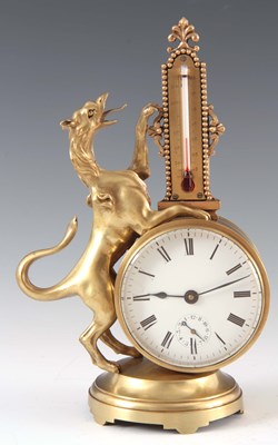 Lot 767 - AN EDWARDIAN BRASS CASED DESK CLOCK modelled...