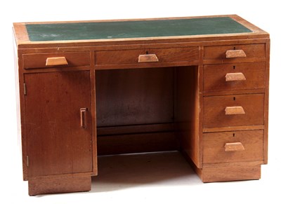 Lot 973 - AN ART DECO OAK DESK with leather writing top...