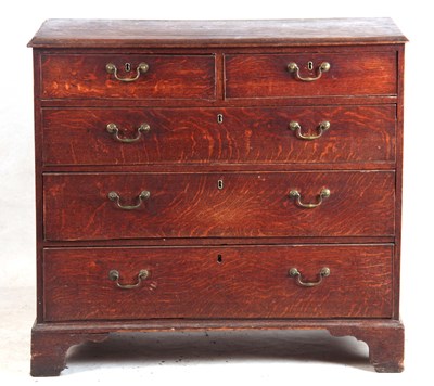 Lot 990 - A GEORGE III OAK CHEST OF DRAWERS with two...